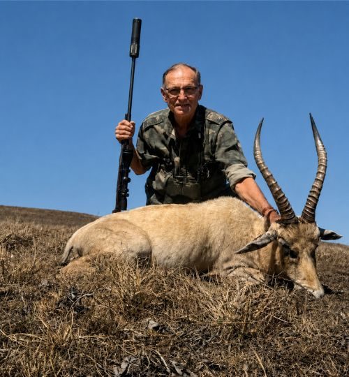 Hunter posing with a trophy blesbok during a plains game hunting safari in South Africa